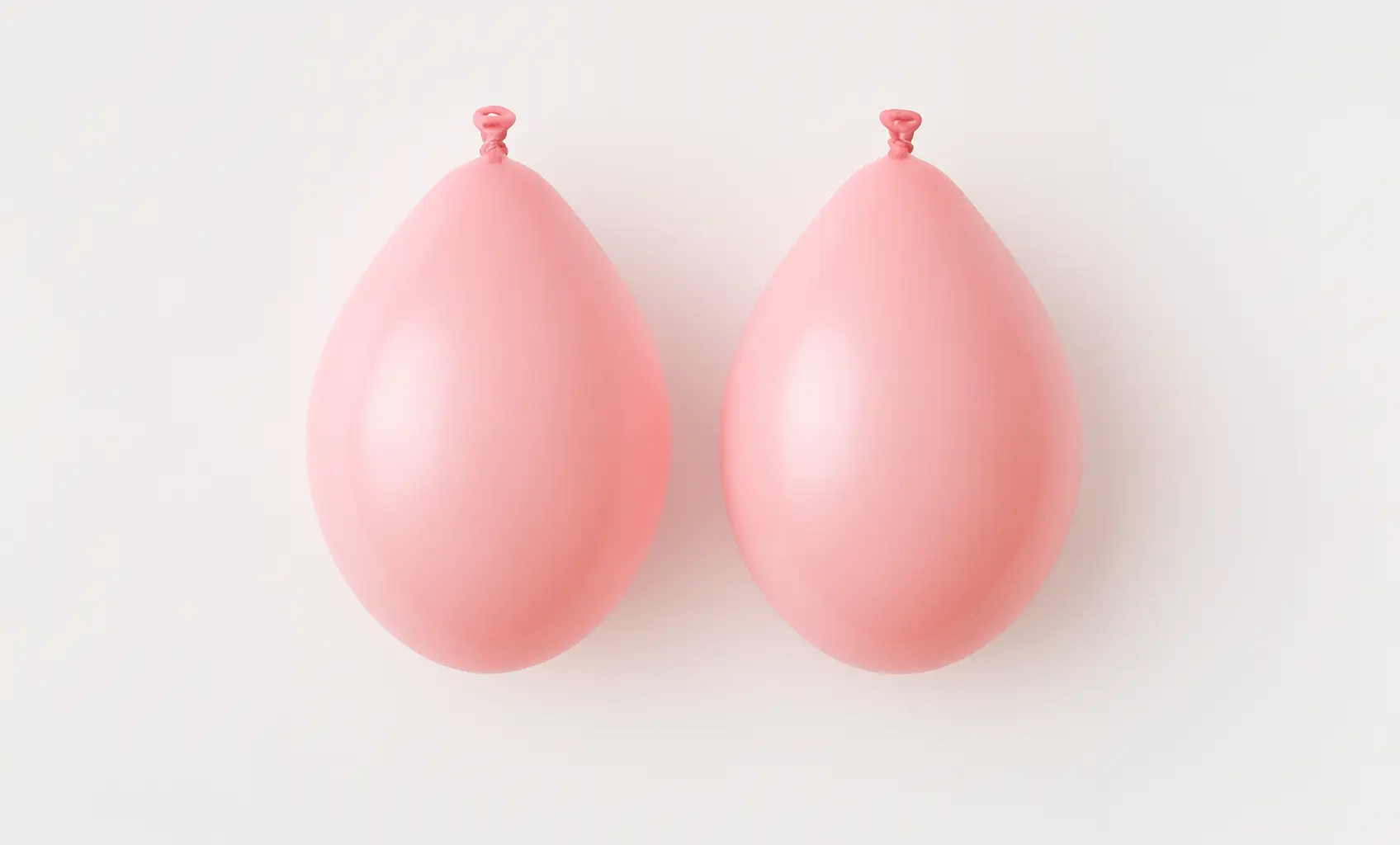 Imagen de dos globos rosas representando los dos pulmones del aparato respiratorio